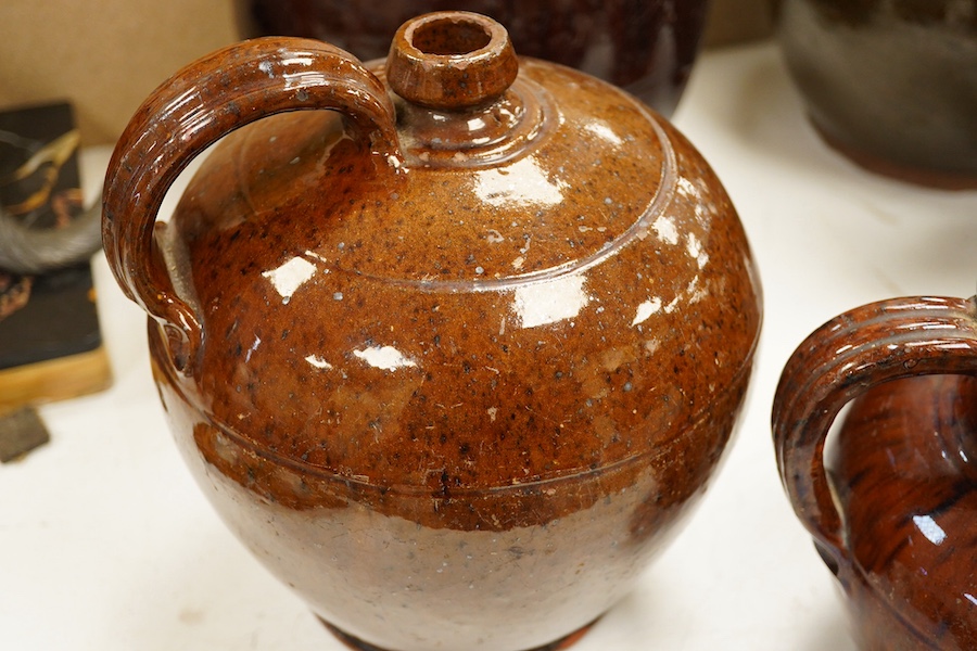 A group of stoneware glazed flagons and jugs, largest 29cm high. Condition - some chips